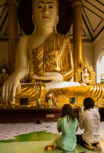 Couple praying, Shwedagon Pagoda temple, Rangoon